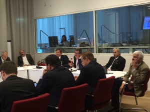 MPP's Greg Perry speaks, flanked by Duneston (left), Mirza (right), and other panellists