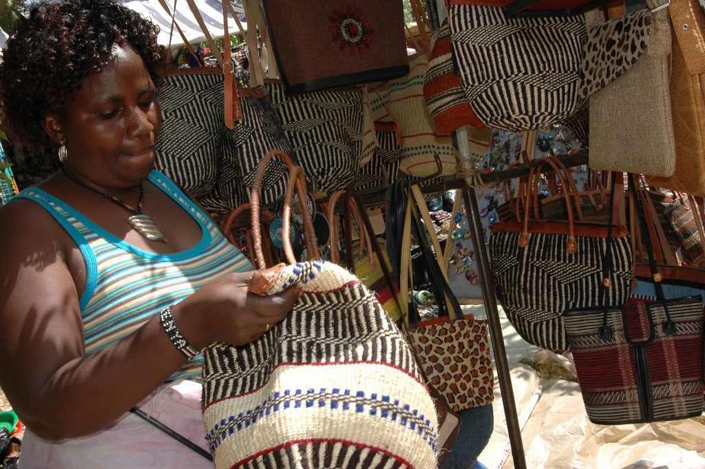 A woman wrapped in Kikoy (Kikoi) looks at a Kiondo basket. The two Kenyan indigenous items have been at the centre of controversy over their IP.