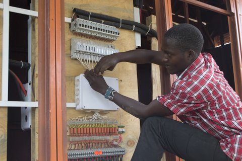 A young Kenyan ICT technician at a solar power hub in Kajiado county south of Nairobi