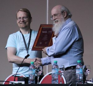 Scott Bradner receives honor for his long service to the IETF in April. To left: Roland Bless, Karlsruhe Institute of Technology