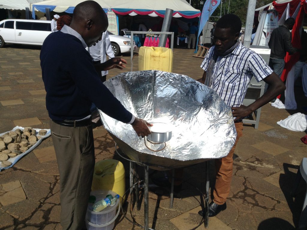 Josephat Ngetich and Cosmas Mibei, students of Friends College Kaimosi, Western Kenya, showcasing how a multi solar cooker they have designed works during the National Science week organised by the National Commission for Science, Technology and Innovation (NACOSTI) and held in Nairobi, Kenya in May 2016